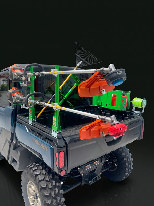 CA100 bed rails carrying trimmers, a rake and a cage on a Can-Am Defender HD11