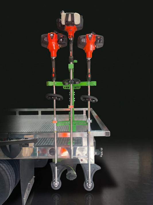 ApeX Series 3-Position Vertical Trimmer Rack (XV103) holding three trimmers, mounted on a trailer rail